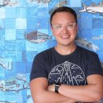 mural of a man with a wall of fish behind him